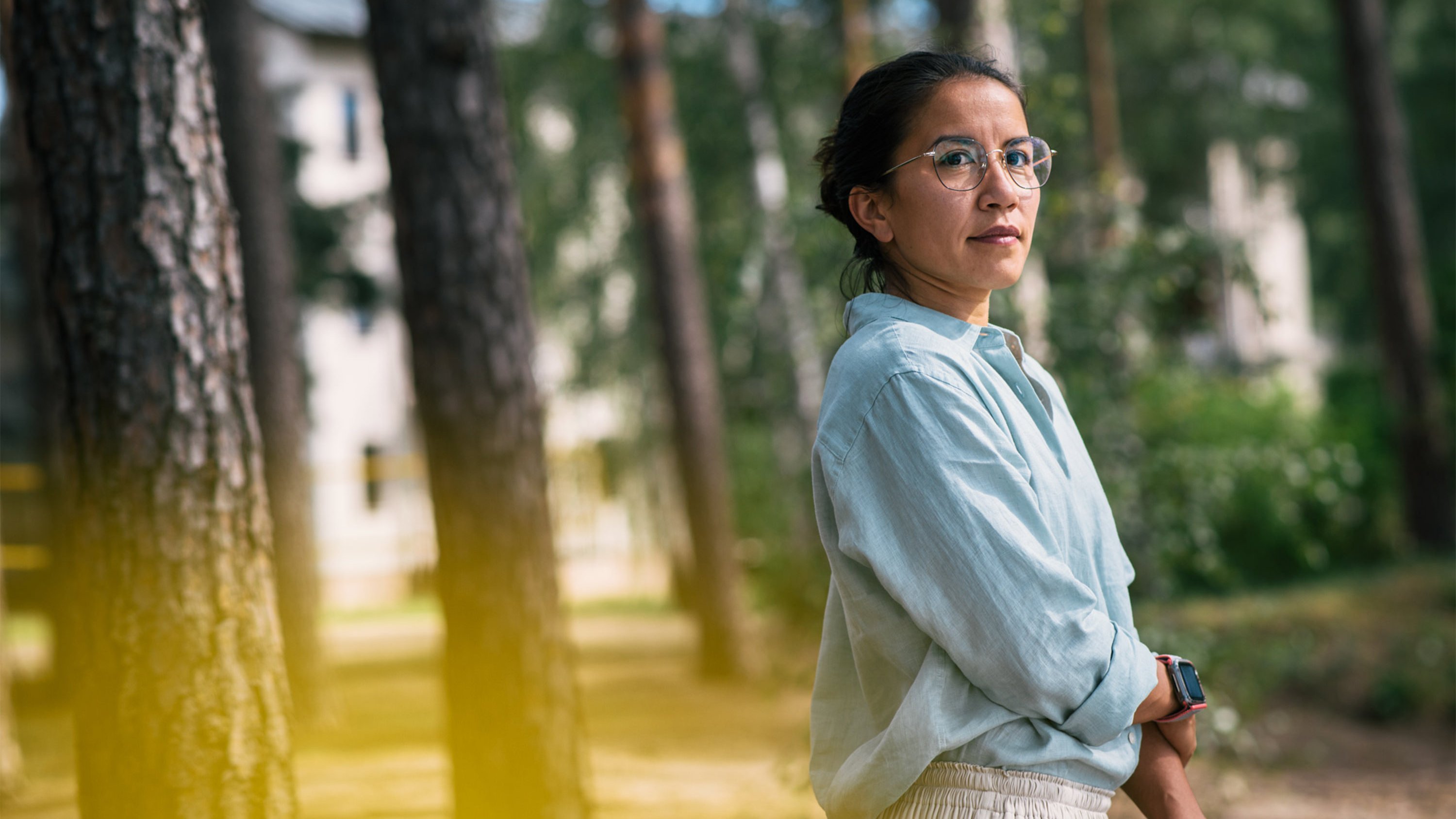 Eine Frau im Profil,  im Hintergrund Bäume: Therapie der Angststörung in heilsamer Umgebung